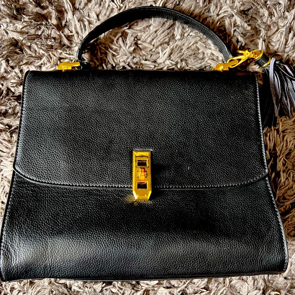 Black attaché style purse with handle and tassel with gold accessories
